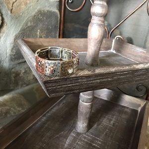 Gold, Silver, and Bronze bracelet saying like Be still & know I am god.